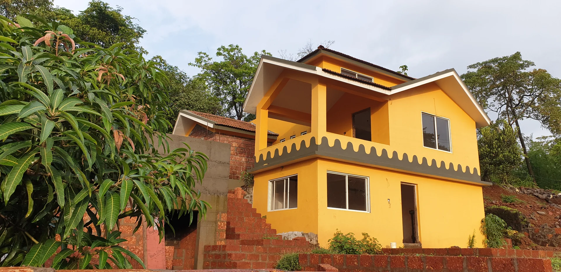 Two-storey yellow villa exterior